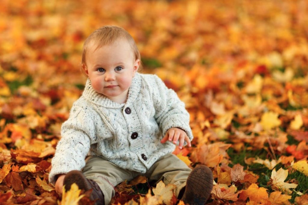 Baby Boy Surrounded by Brown Leaves