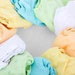 A top-view of colorful cloth diapers arranged in a circular pattern showcasing vivid hues and comfort.