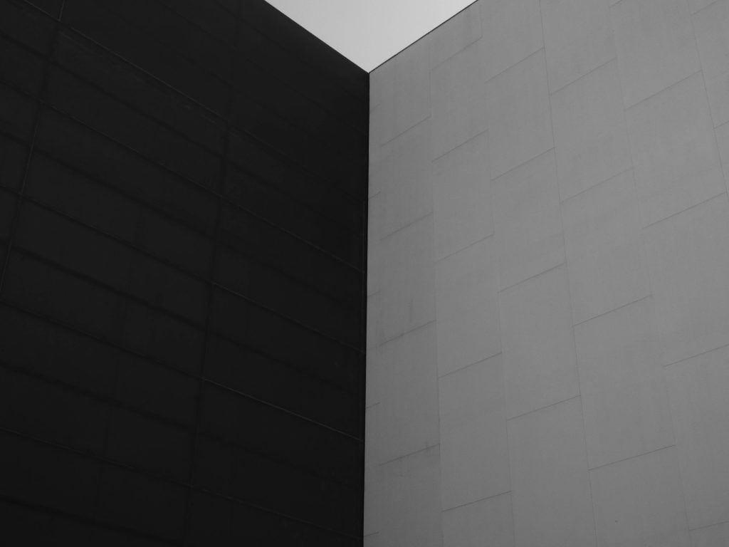 A minimalist black and white wall showcasing architectural contrast and urban design.